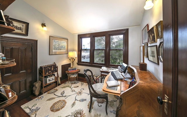 office with vaulted ceiling and dark wood-type flooring