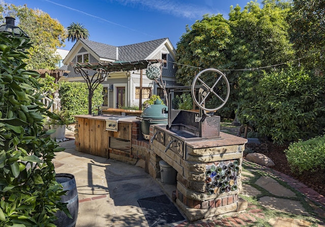 view of patio featuring exterior kitchen and grilling area