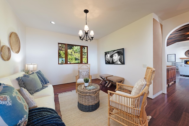 living room featuring a chandelier and dark hardwood / wood-style floors