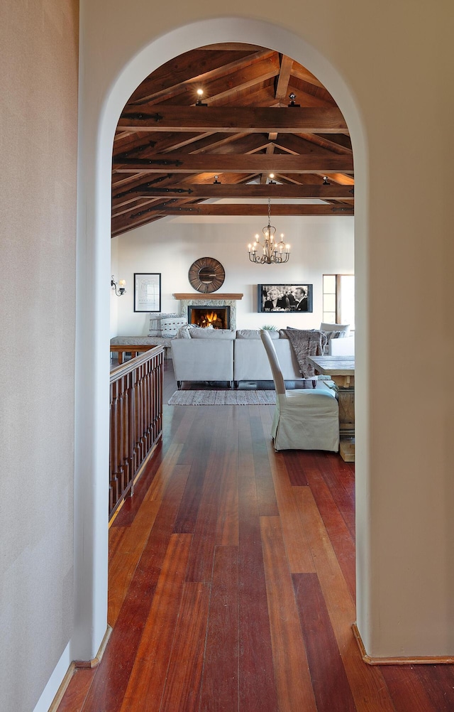 corridor featuring hardwood / wood-style floors, lofted ceiling with beams, and wood ceiling