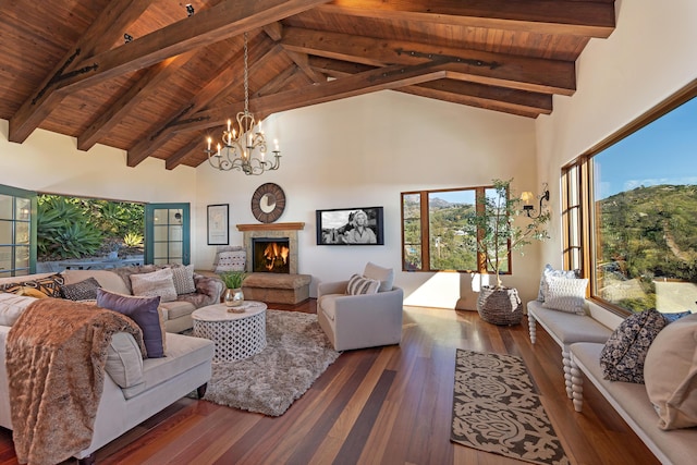 living room with a notable chandelier, beam ceiling, dark hardwood / wood-style flooring, and high vaulted ceiling