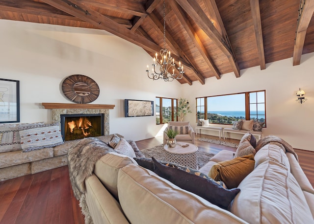 living room featuring wood ceiling, beam ceiling, an inviting chandelier, a premium fireplace, and hardwood / wood-style floors