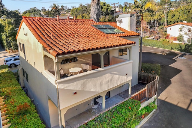 back of property featuring a balcony