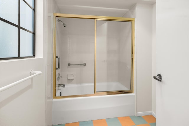 bathroom with combined bath / shower with glass door