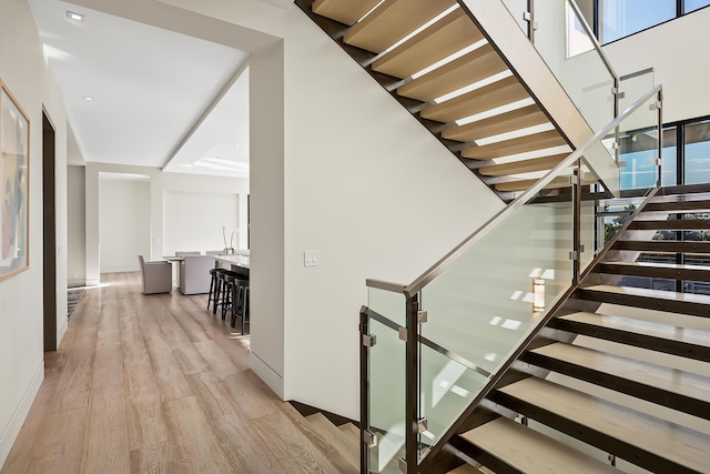 stairs featuring hardwood / wood-style floors