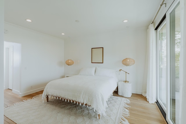 bedroom with crown molding and light hardwood / wood-style flooring