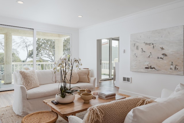 living room featuring hardwood / wood-style flooring and ornamental molding