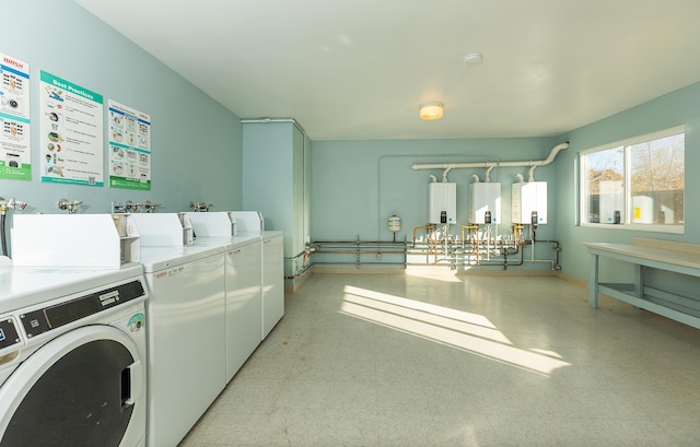 washroom featuring washing machine and dryer and tankless water heater