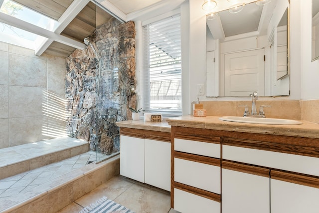 bathroom with a skylight and vanity