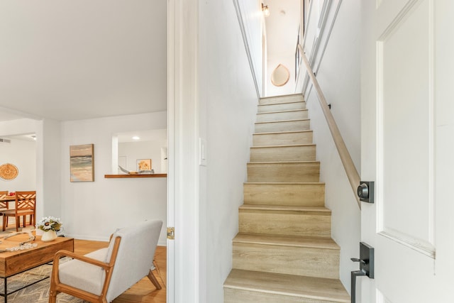 stairs featuring wood-type flooring