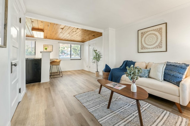 living room with light hardwood / wood-style flooring, wooden ceiling, and crown molding