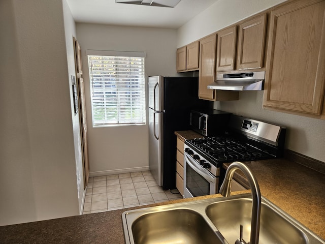 kitchen with light tile patterned flooring, appliances with stainless steel finishes, and sink