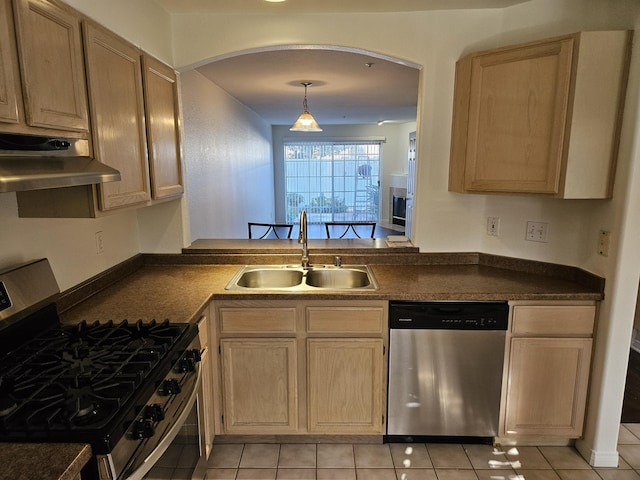 kitchen featuring stainless steel appliances, sink, light tile patterned floors, light brown cabinets, and decorative light fixtures