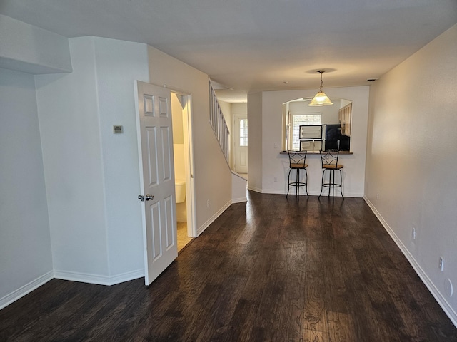 hallway with dark hardwood / wood-style floors