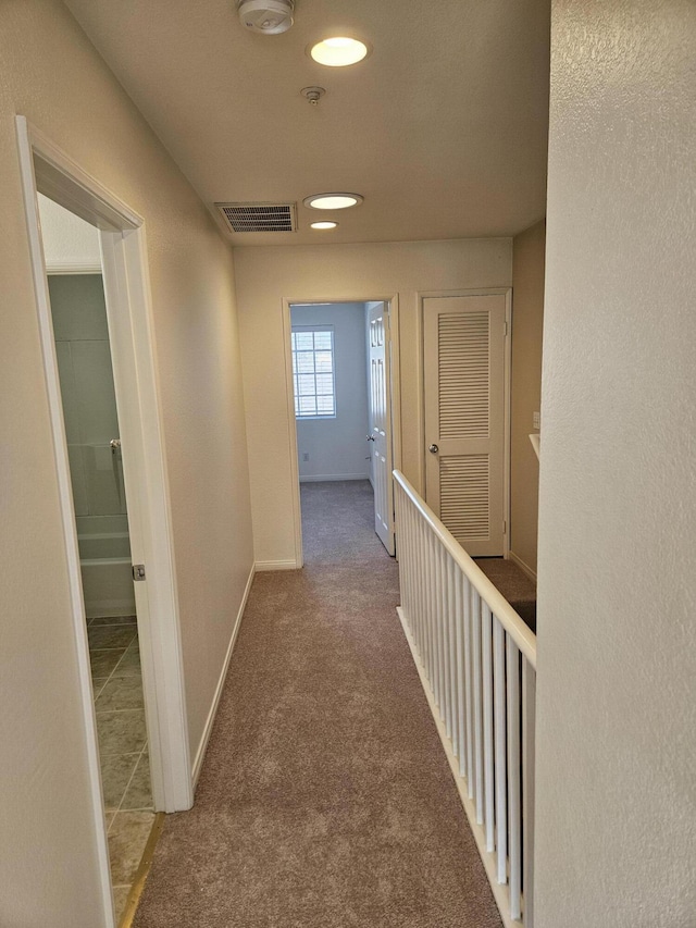 hallway featuring carpet