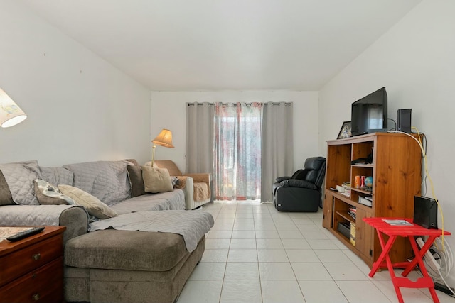 living room with light tile patterned flooring and vaulted ceiling