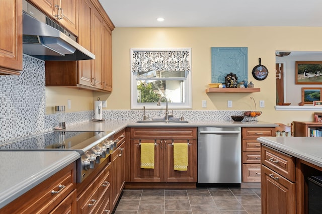 kitchen featuring stainless steel appliances, dark tile patterned floors, decorative backsplash, and sink