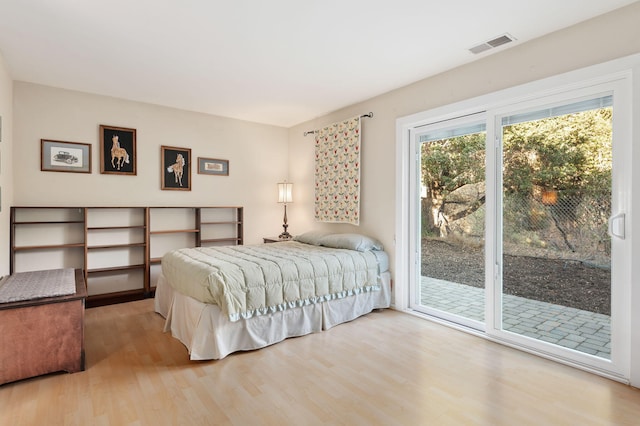 bedroom with light hardwood / wood-style flooring and access to outside