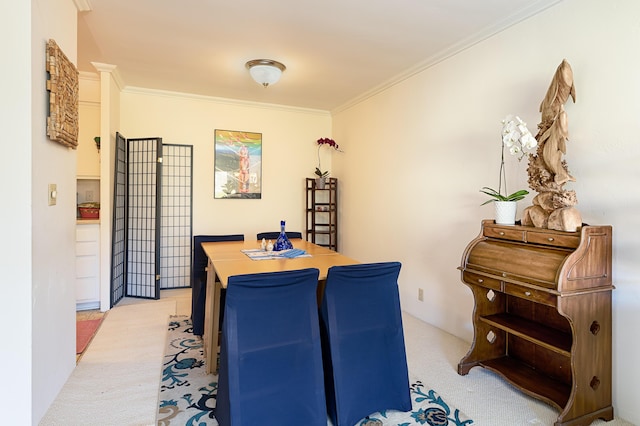 dining space featuring light colored carpet and crown molding