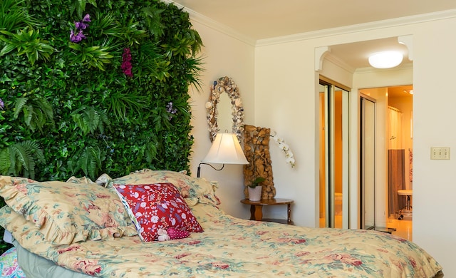 bedroom featuring ensuite bath and crown molding