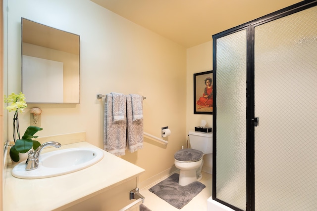 bathroom featuring toilet, a shower with door, vanity, and tile patterned flooring