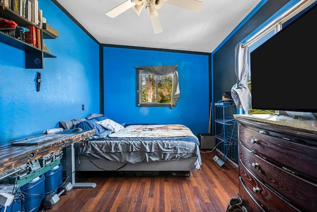 bedroom featuring ceiling fan, dark wood-type flooring, and ornamental molding