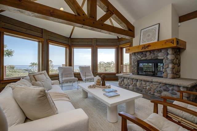 living room with high vaulted ceiling, a wealth of natural light, a fireplace, and beamed ceiling