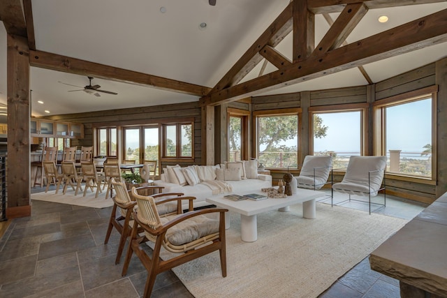 living area with high vaulted ceiling, recessed lighting, stone tile floors, a ceiling fan, and beam ceiling