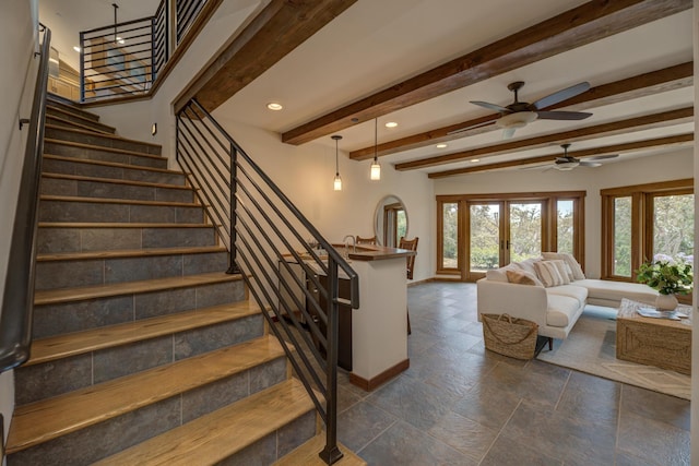 staircase with beamed ceiling, recessed lighting, a wealth of natural light, and baseboards