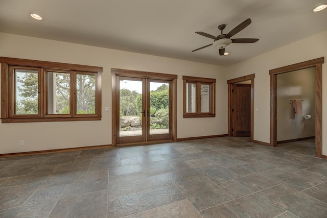 unfurnished room featuring ceiling fan, recessed lighting, baseboards, french doors, and stone finish flooring