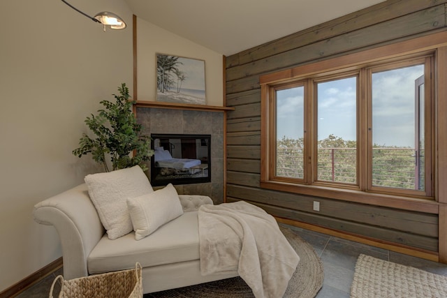 bedroom featuring a fireplace, vaulted ceiling, and baseboards