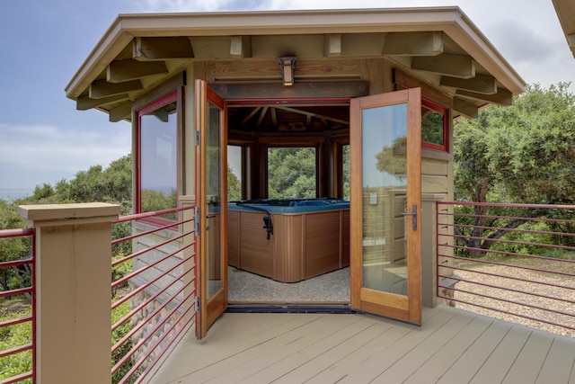 deck featuring a hot tub