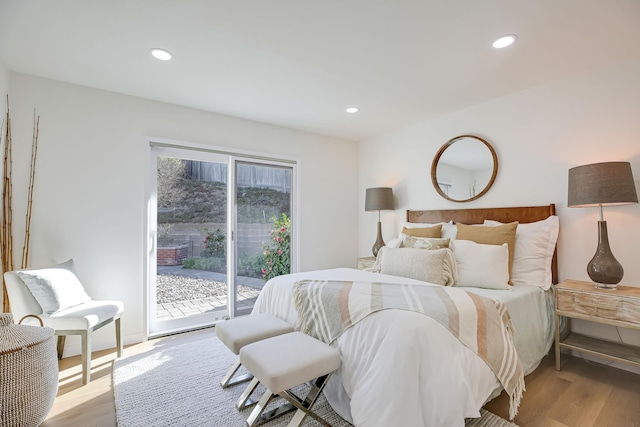 bedroom with access to exterior and light wood-type flooring