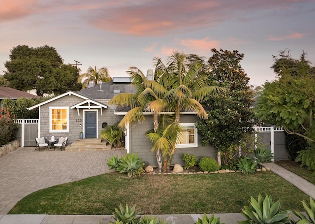 view of front facade with a patio and a yard