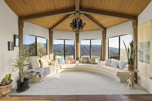 sunroom / solarium featuring a notable chandelier, wooden ceiling, lofted ceiling with beams, and a mountain view