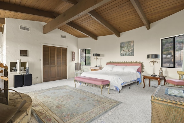 bedroom featuring wooden ceiling, a closet, carpet, and beamed ceiling