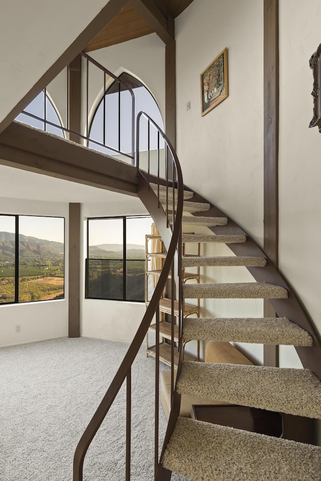 staircase with a wealth of natural light and a mountain view