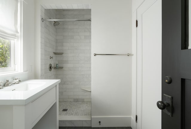 bathroom featuring vanity and a tile shower