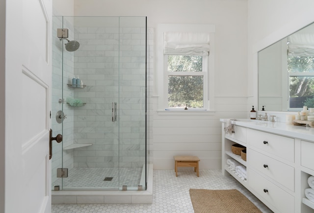 bathroom featuring walk in shower, vanity, and tile patterned flooring