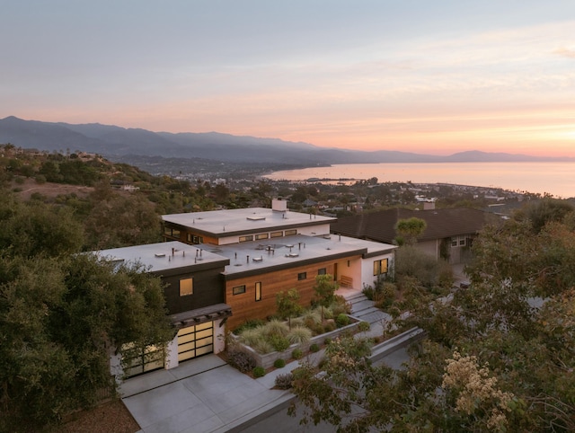 aerial view at dusk featuring a mountain view