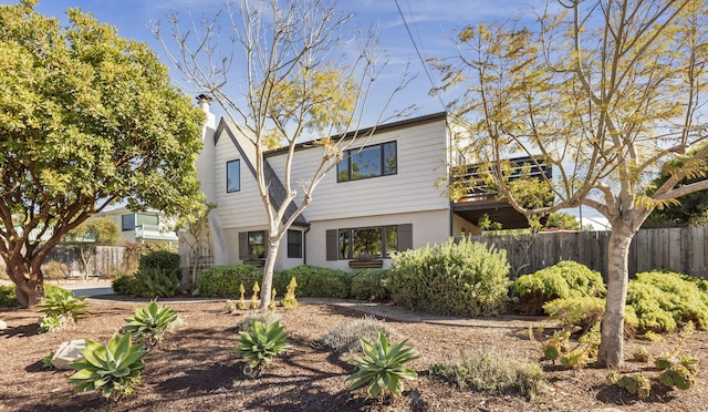 view of front of property featuring fence