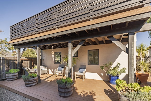 deck with an outdoor hangout area and fence