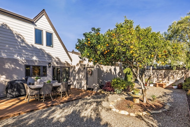 view of yard with outdoor dining area, fence, and a deck