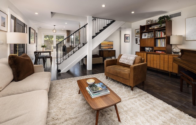 living room with recessed lighting, visible vents, and stairway