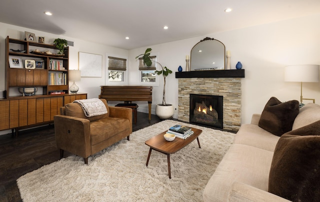 living room with a fireplace, wood finished floors, and recessed lighting