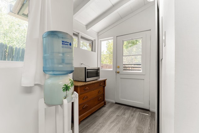 entryway featuring light hardwood / wood-style flooring and lofted ceiling with beams