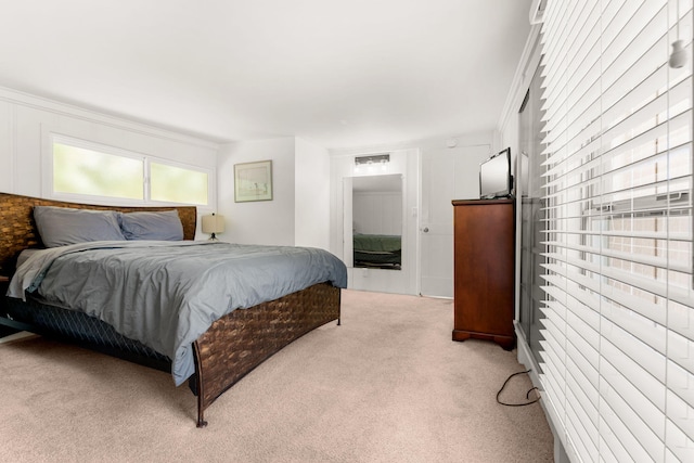 carpeted bedroom featuring crown molding