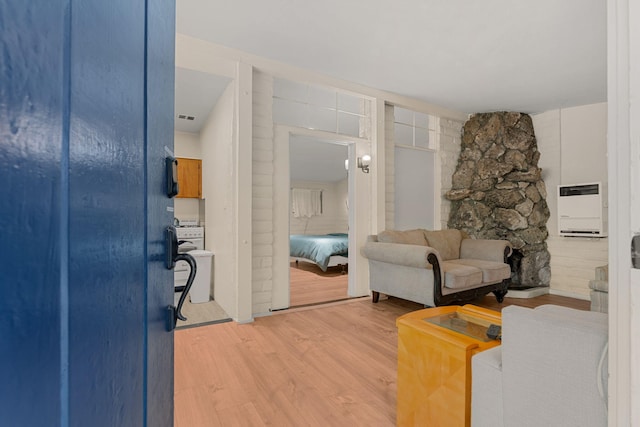 living room featuring heating unit and hardwood / wood-style flooring