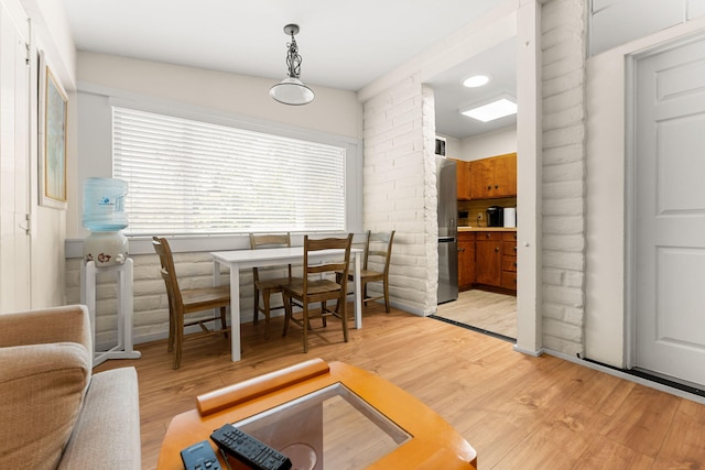 dining space with light wood-type flooring