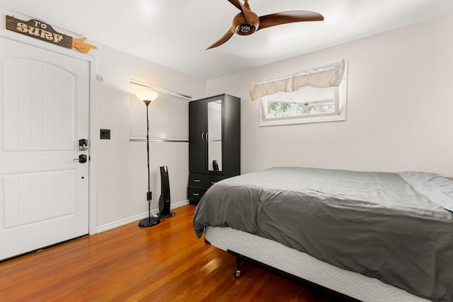 bedroom featuring hardwood / wood-style floors and ceiling fan